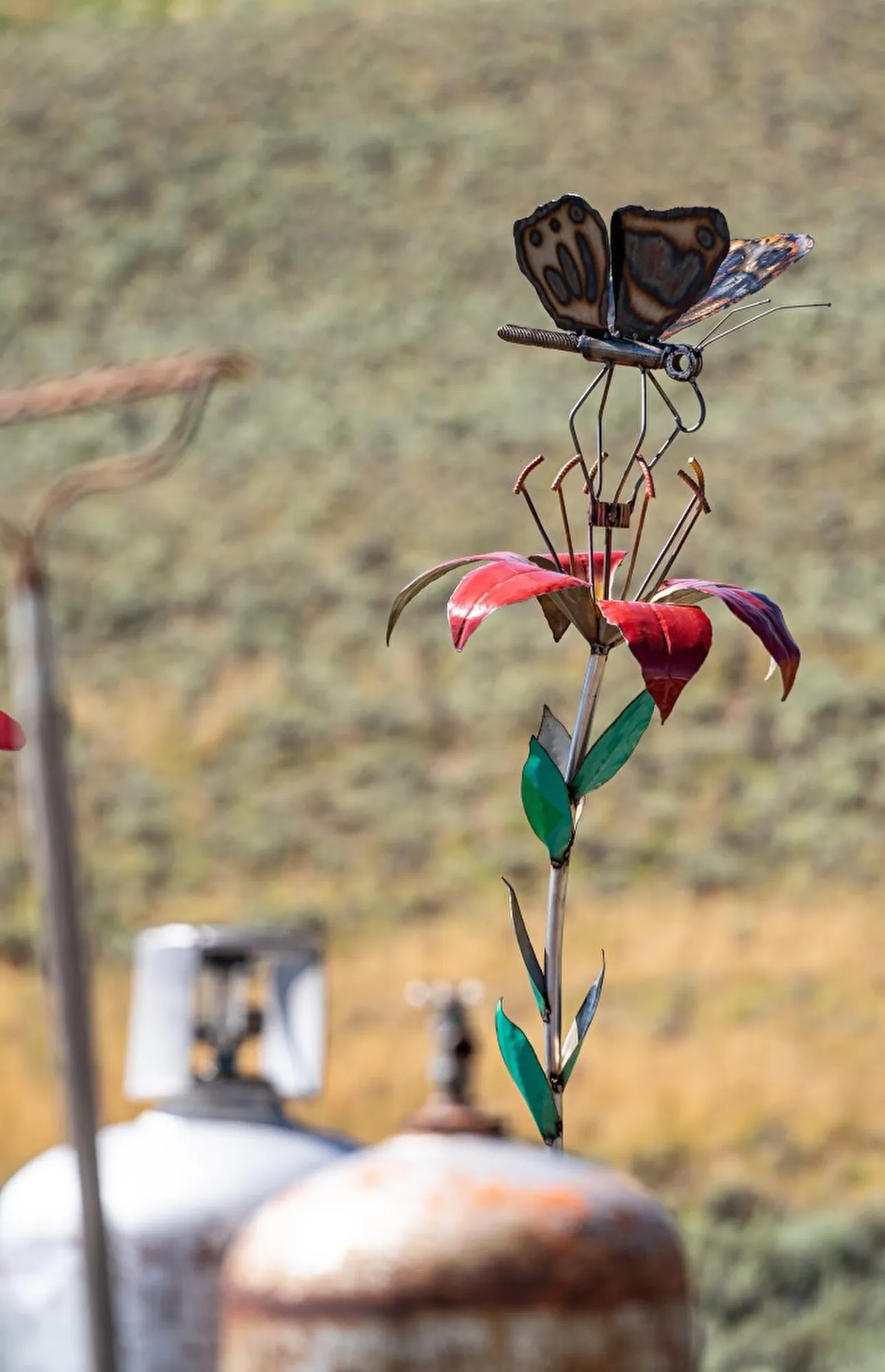 Wood Lily with Butterfly, Reclaimed 55 gallon steel drum and pipe; timing gear; spinning butterfly
